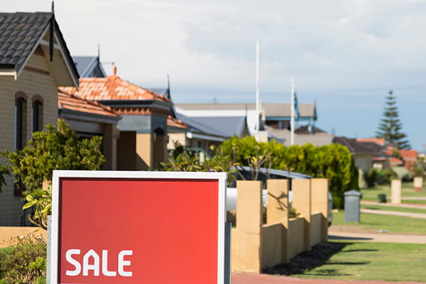 A for sale sign in front of a home