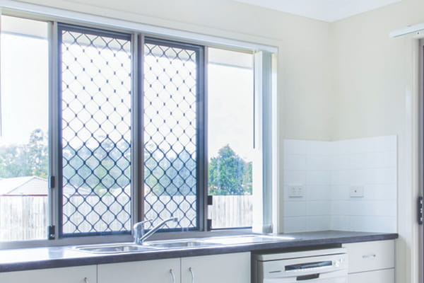 Kitchen with security screens on the windows