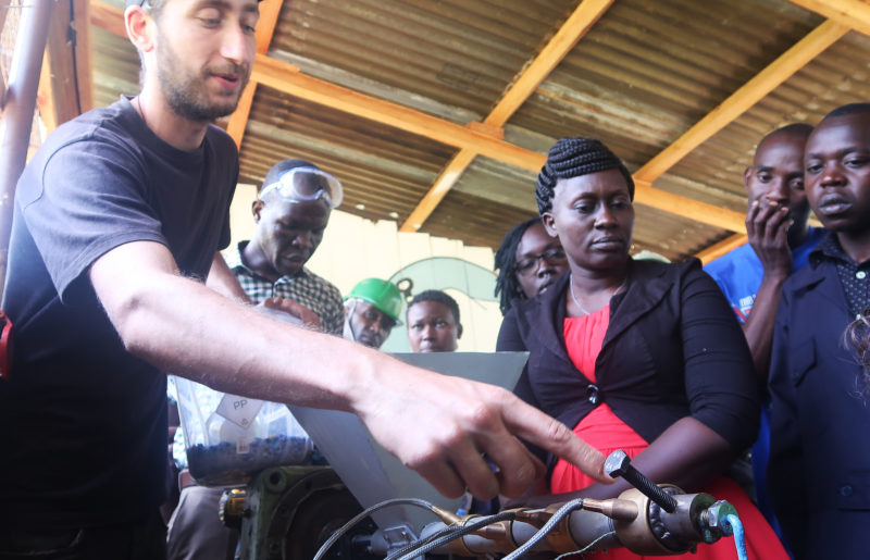 man showing a machine to  a woman