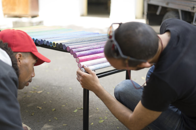 men working on a plastic bench