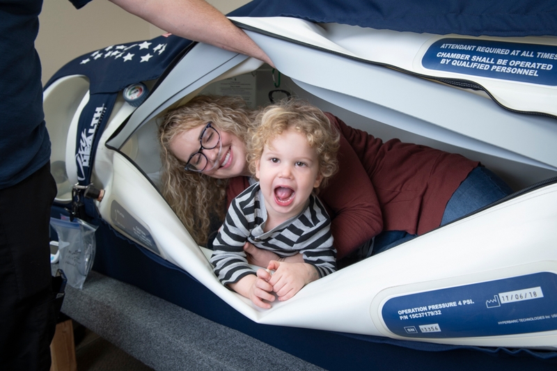 mom and kid in hyperbaric chamber