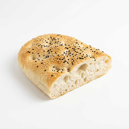 A piece of Turkish bread topped with sesame and nigella seeds