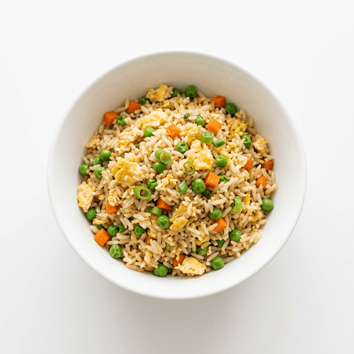 A bowl of egg fried rice with peas and carrot
