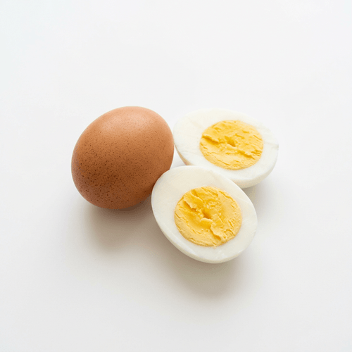Two boiled eggs, one whole and one halved