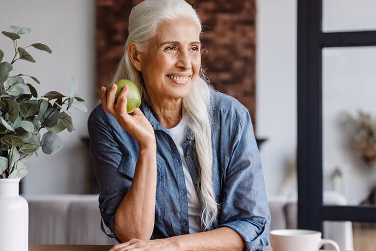 Older woman eating for better cognition and ageing gracefully