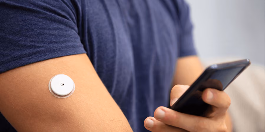 A man wearing a CGM device for healthy blood sugar levels