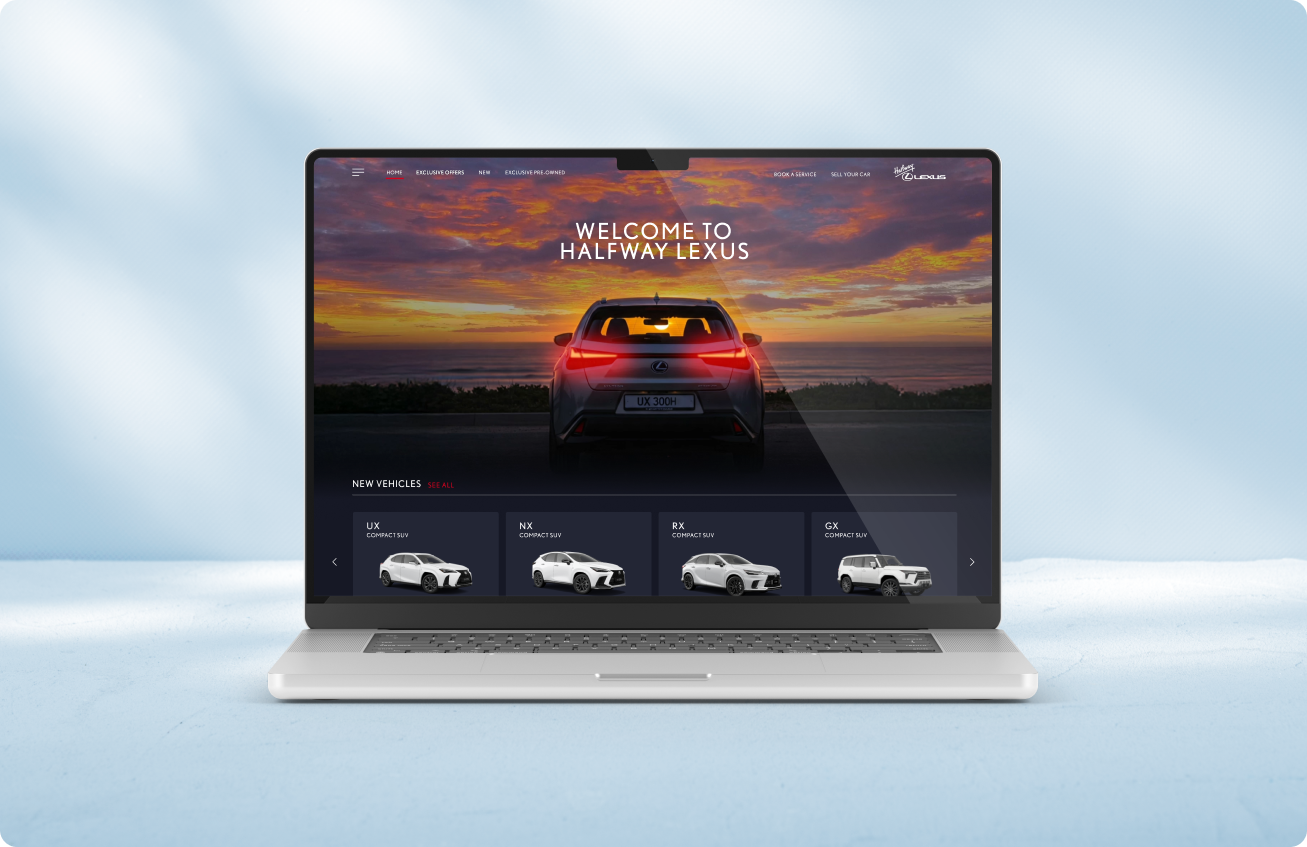 Laptop displaying a Lexus website homepage with a rear view of a Lexus vehicle against a sunset background and selections of new Lexus compact SUV models UX, NX, RX, and GX.