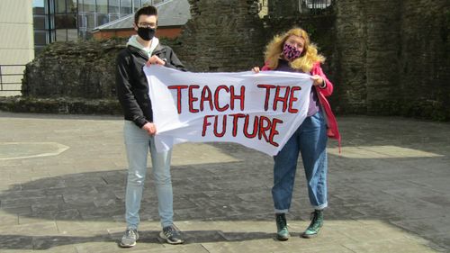 Students with teach the future banner
