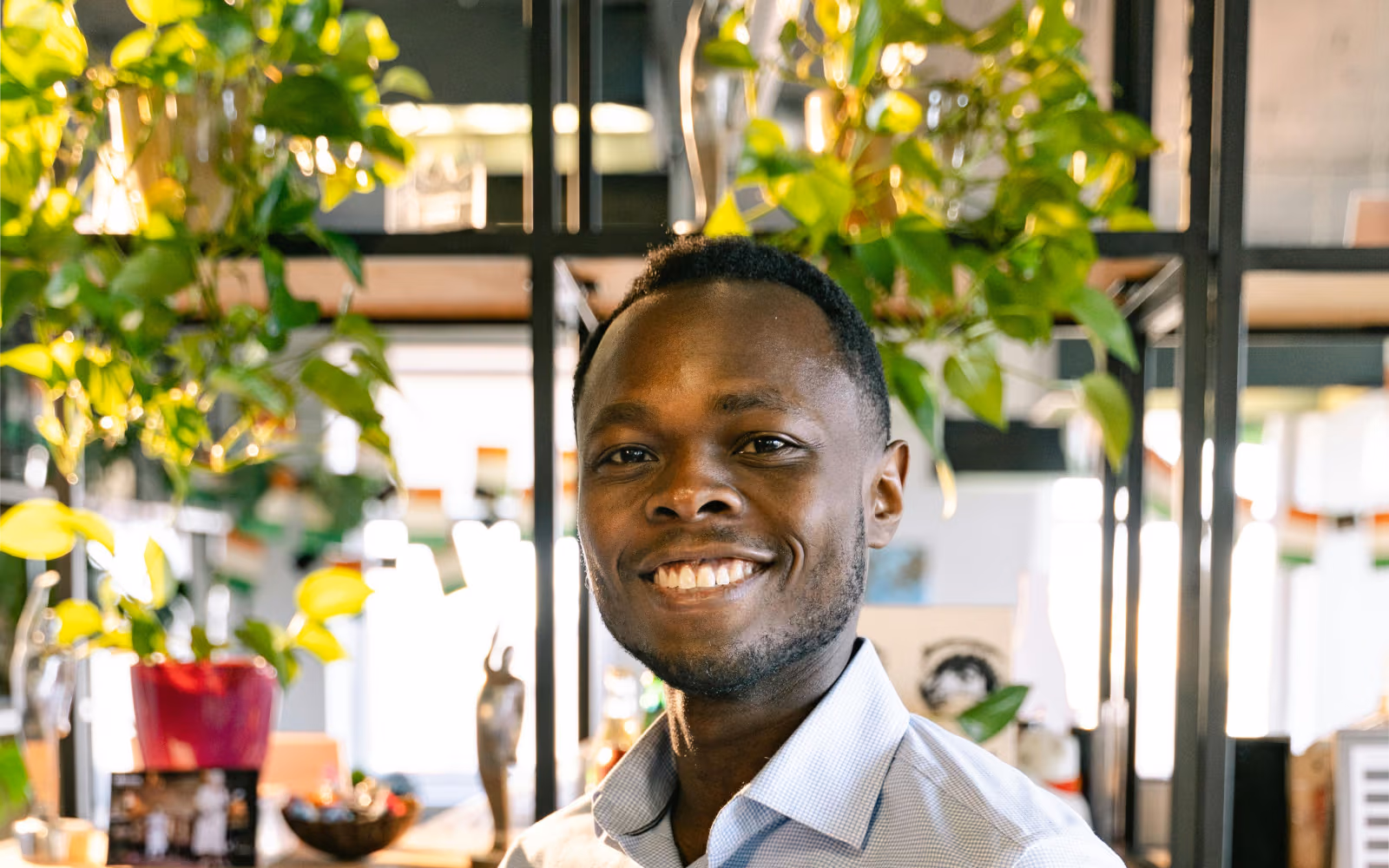 Smiling man in a dark shirt in a café