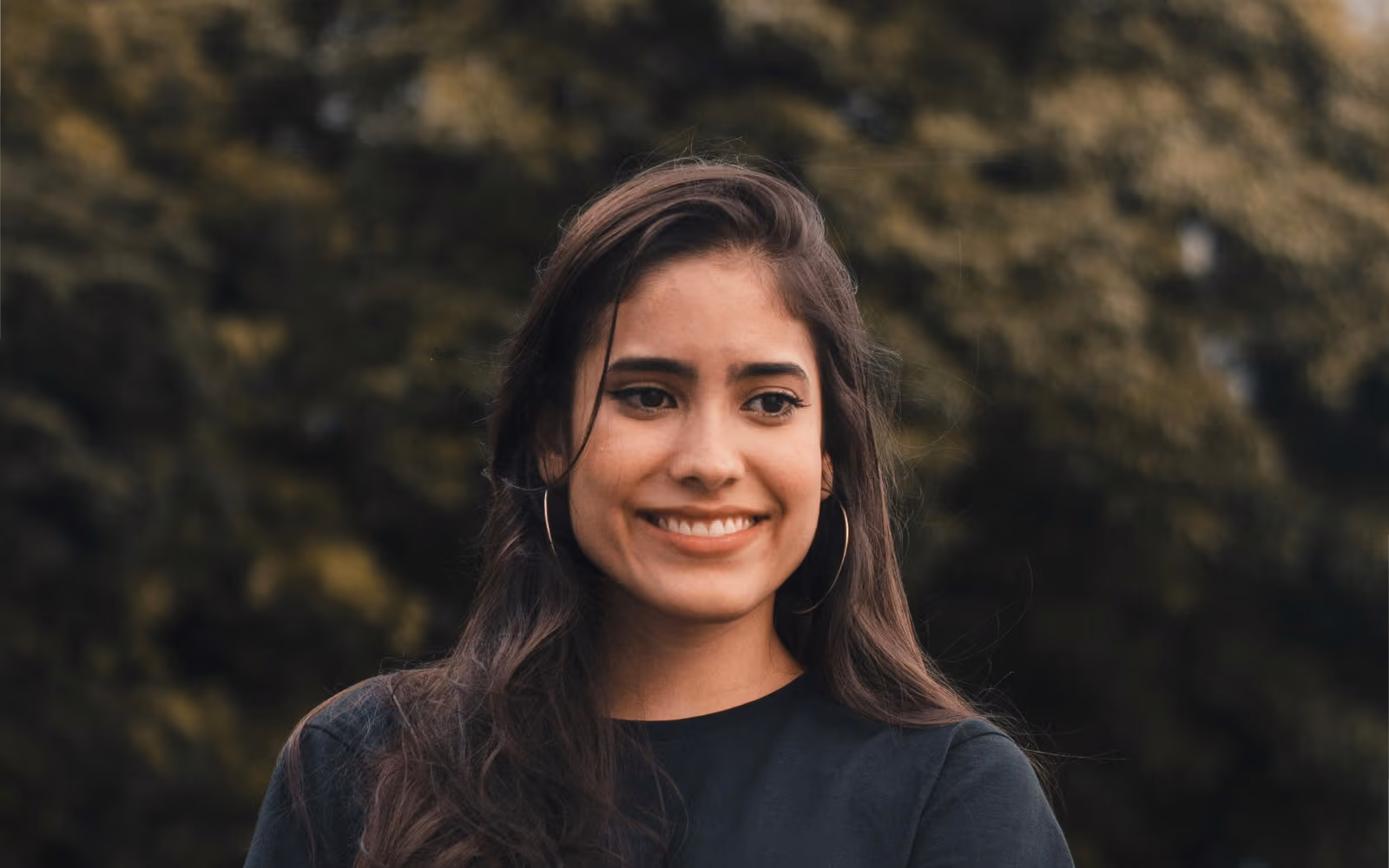 Smiling woman against a dark background
