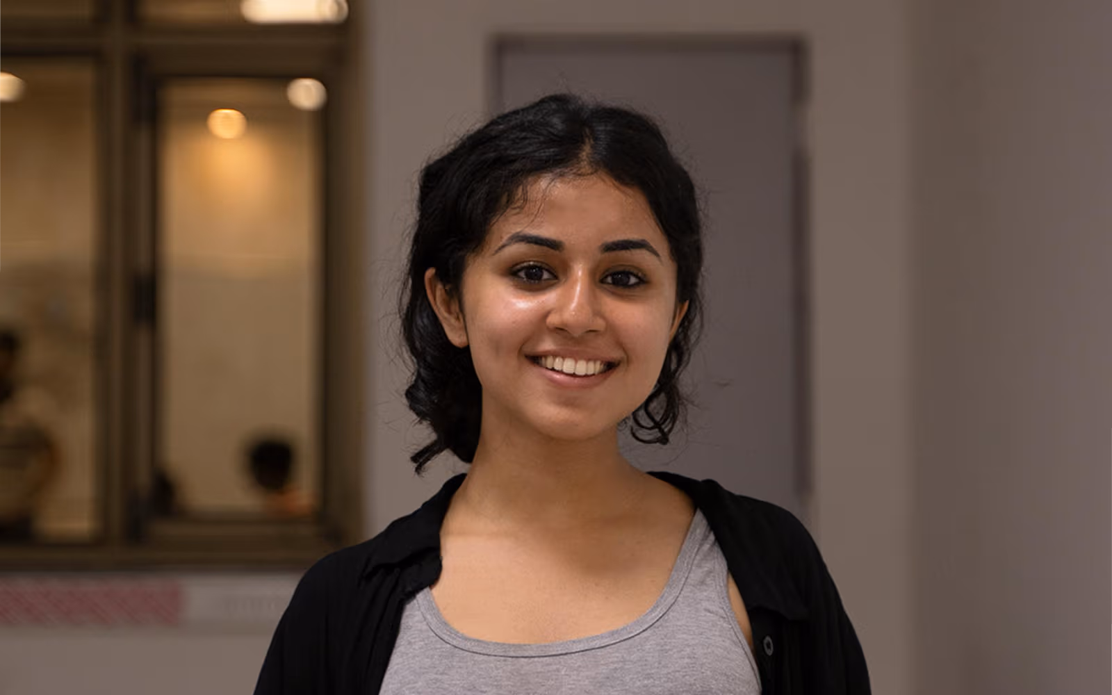 Smiling woman in a grey top indoors