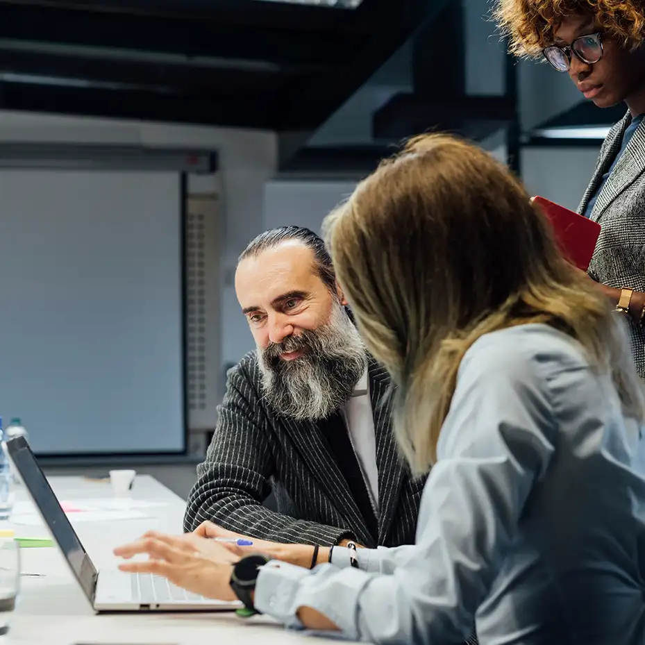 2 executives doing a Teamland AI corporate training workshop on a table