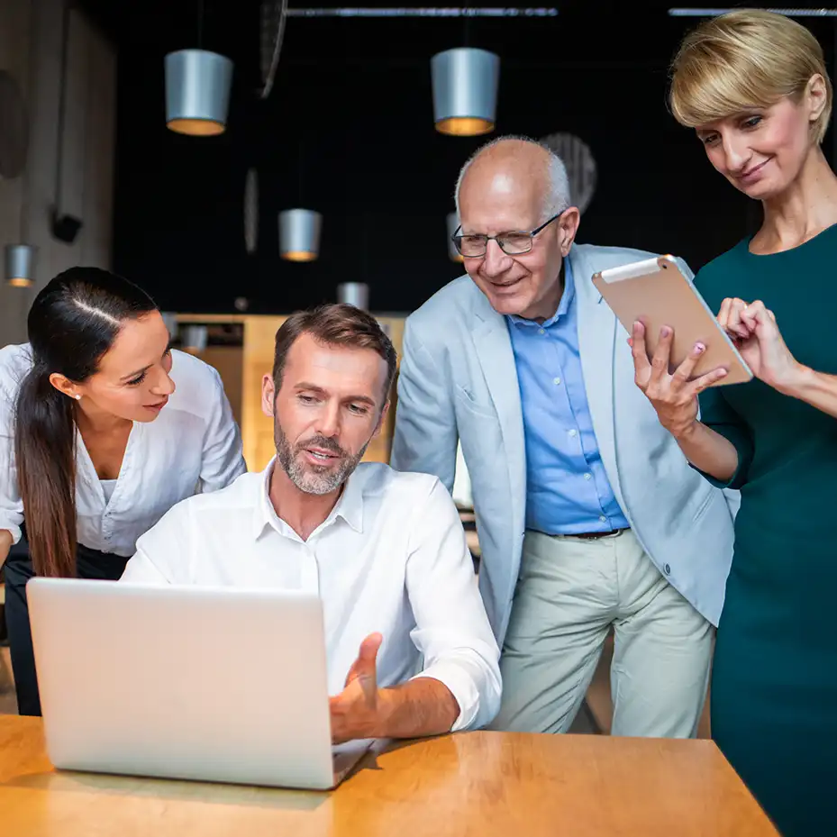 2 executives doing a Teamland AI corporate training workshop on a table