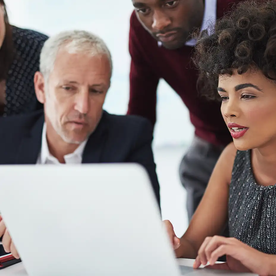 2 executives doing a Teamland AI corporate training workshop on a table