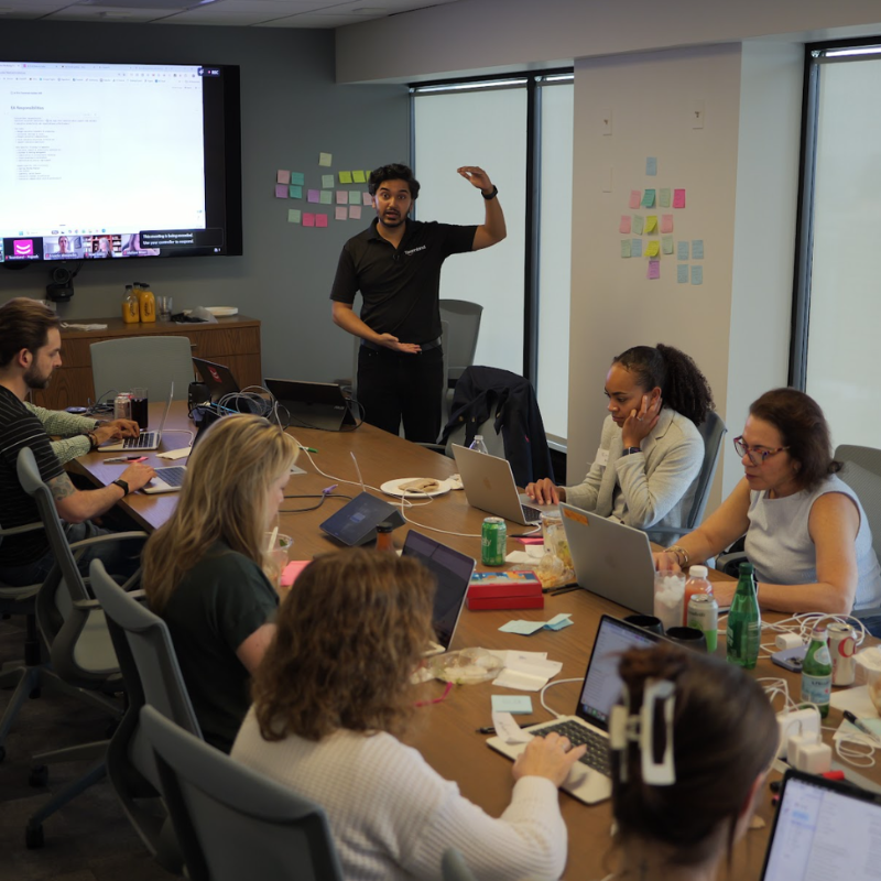 2 coworkers doing a Teamland corporate training workshop and team building infront of a whiteboard
