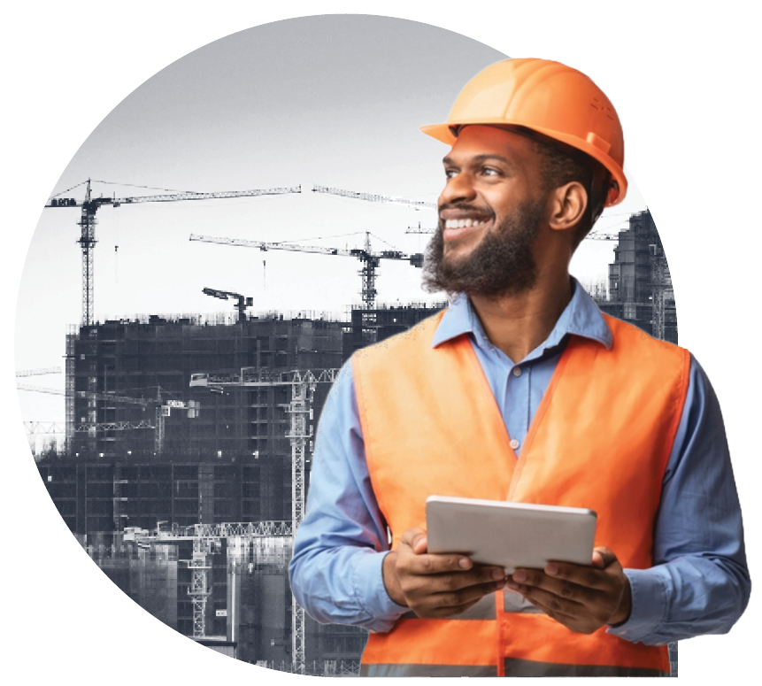 A construction worker in safety gear with a building being constructed in the background.