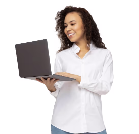 A professional standing and typing on her laptop.