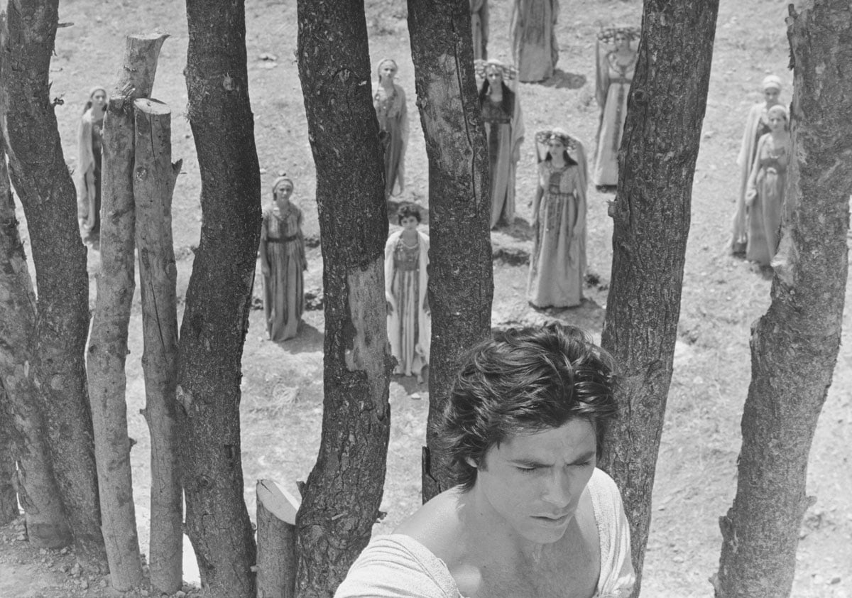 Still from Iphigenia showing man from above close to camera, women in distance