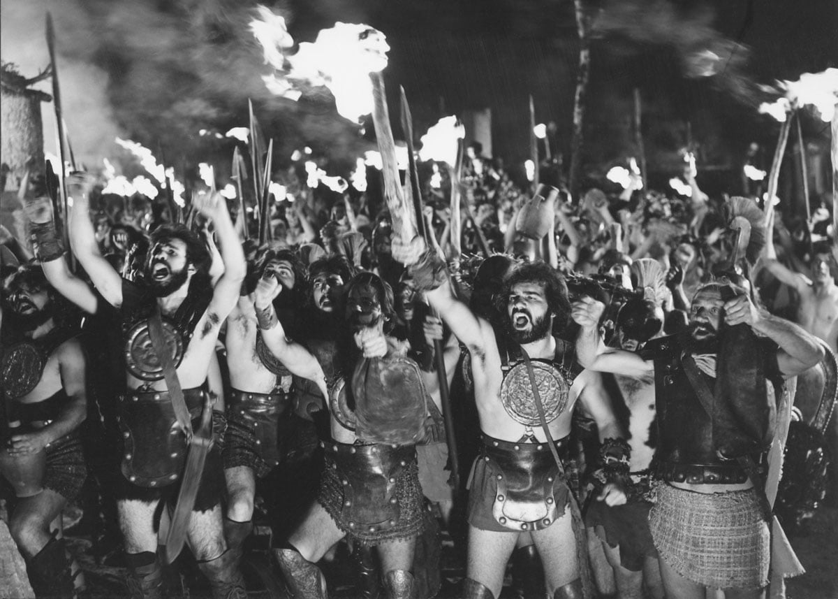 Film still from Iphigenia showing band of raging warriors at night