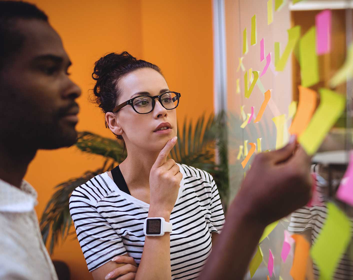 Team brainstorming session with sticky notes during a project planning meeting.