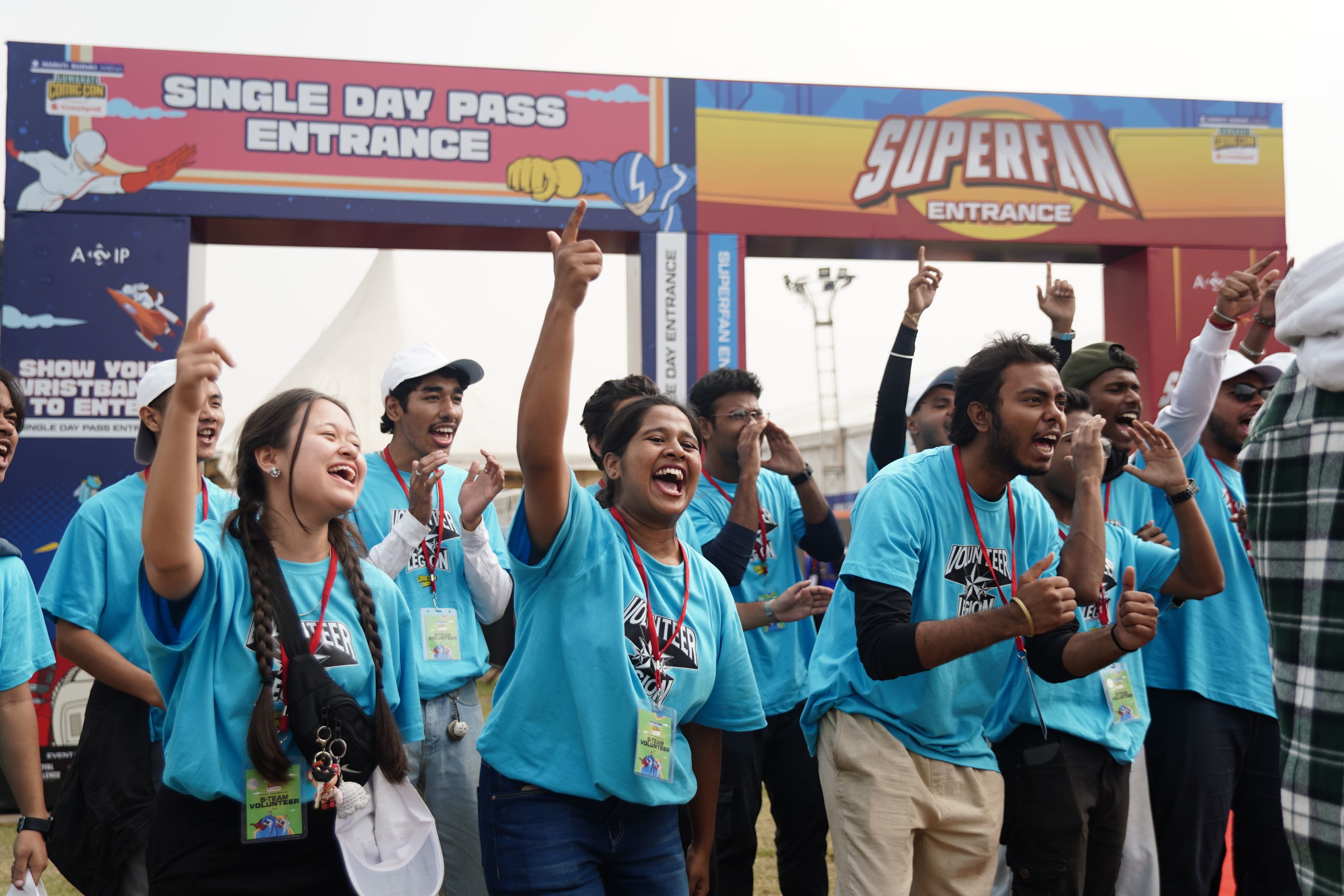Volunteers high-fiving convention goers