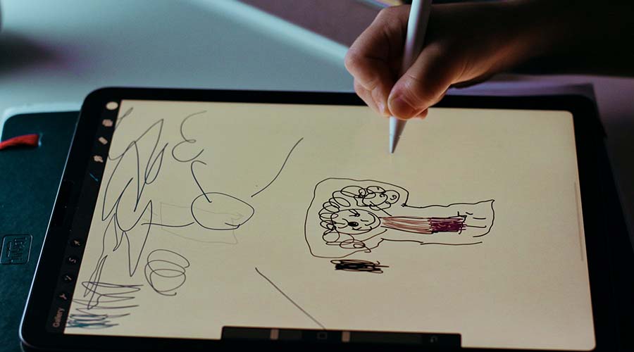 Child using a drawing app on a tablet