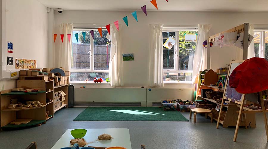 A bright, light room full of toys at Friendly Families Nursery