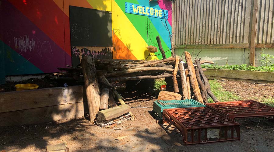 A view of the garden with a rainbow wall at Friendly Families Nursery