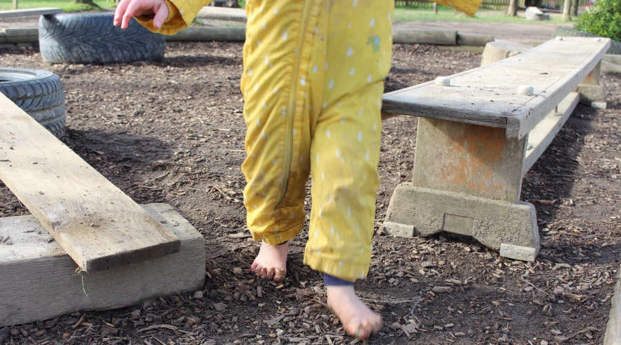 Barefoot kid walking outside