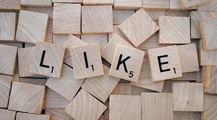 Scrabble pieces forming the word 'like'