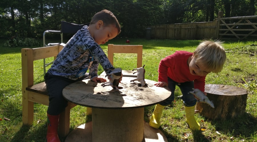 two children playing outdoors in the garden at Deerness Valley