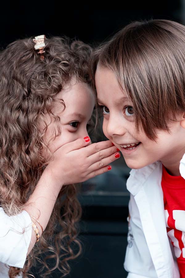 Children at nursery making up their own stories for fun