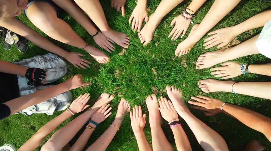 People gathering hands and feet in center