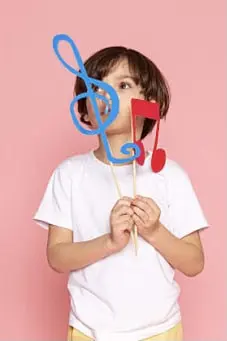 boy holding colourful musical notes