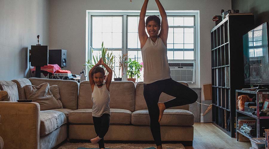 Woman and girl doing yoga together