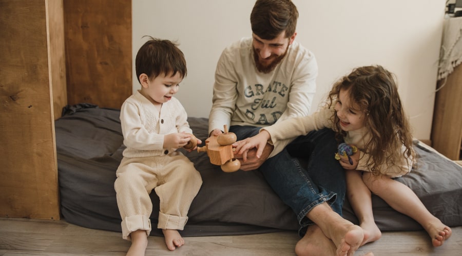 Kids playing barefoot with their father