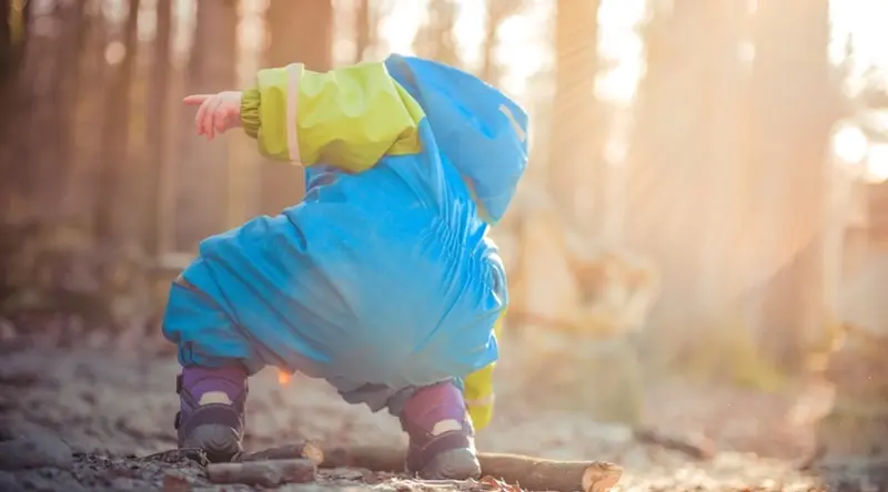 Kid playing outdoors in a forest