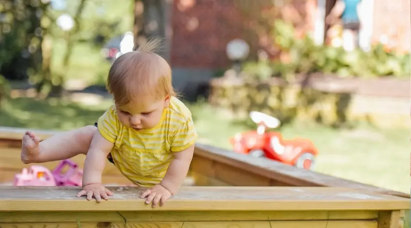 Toddler trying to leave the sandbox