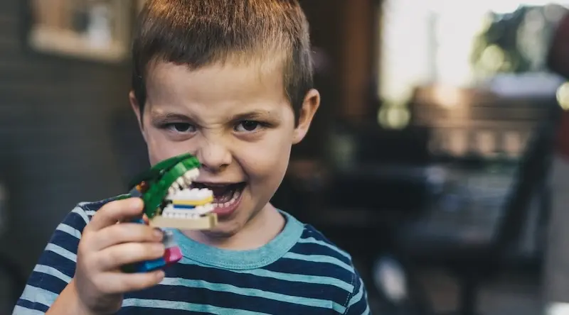 Boy playing with a plastic toy