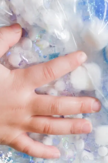 baby hand on a plastic bag with semi-liquid stuff