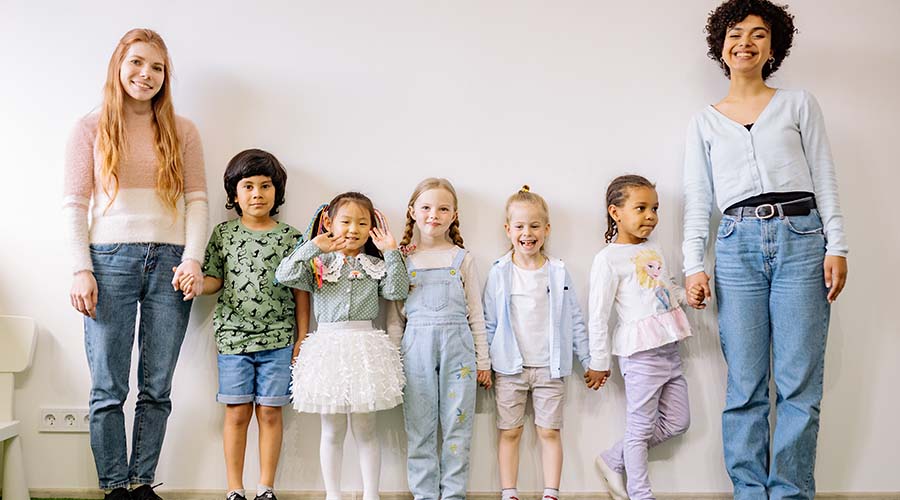 Group picture of early years staff in their nursery with children
