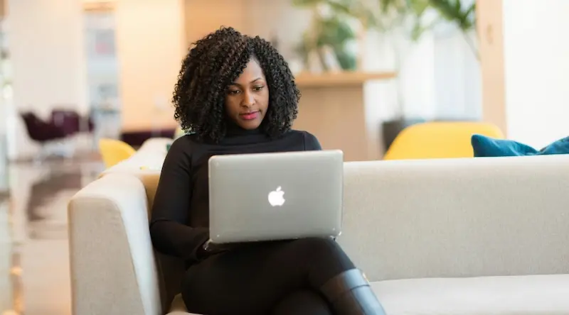 a woman making a childcare budget on her laptop