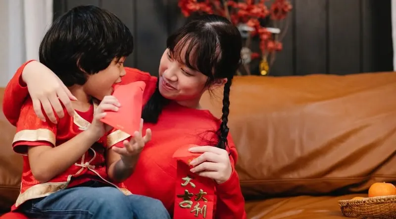 two siblings smiling and playing together