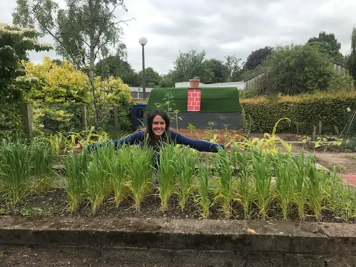 Andrea with the setting's wheat crop in the nursery garden
