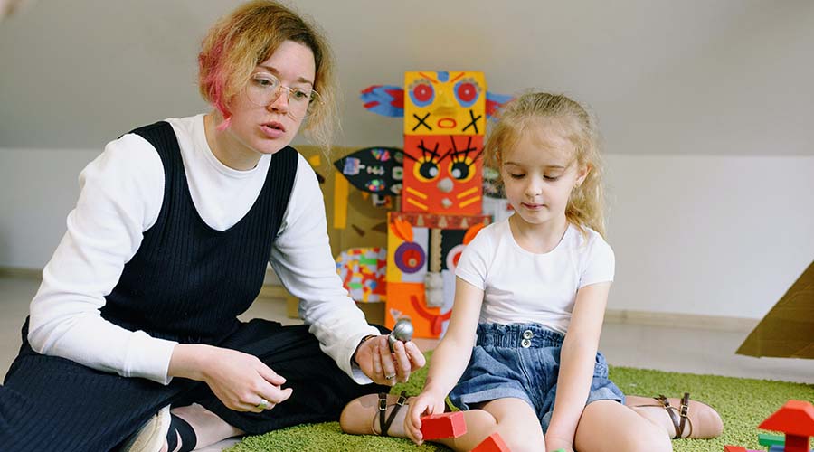 teacher explaining science experiments to a young girl