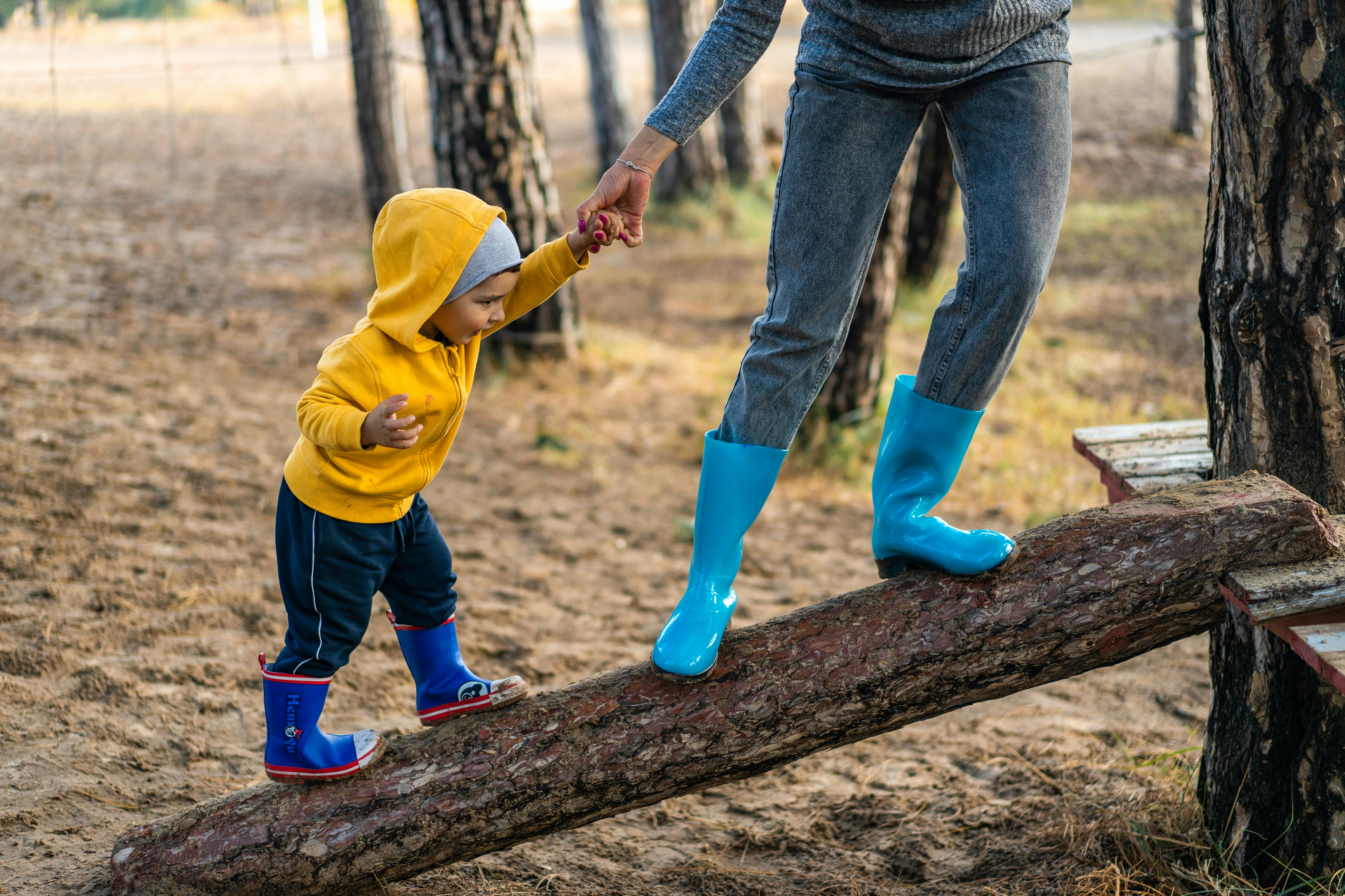 a child playing with his parent in the forest