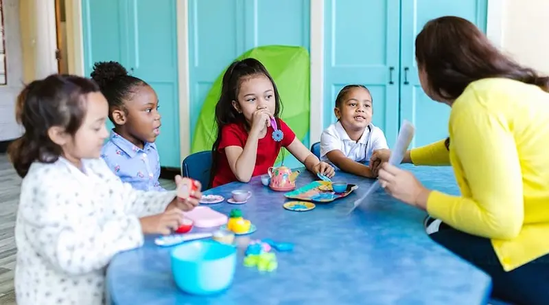 children having tea partyin blue room