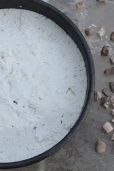 Round cake pan filled with flour