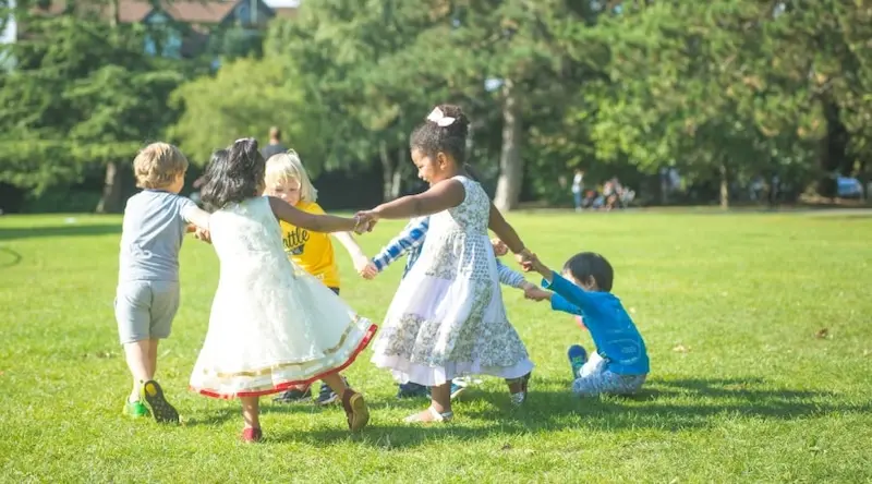 Children holding hands and dancing