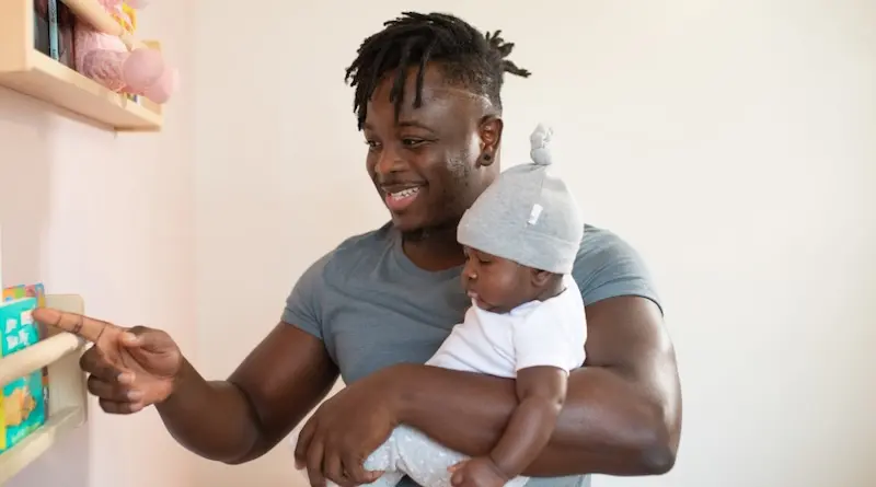 Smiling father has a moment with his baby